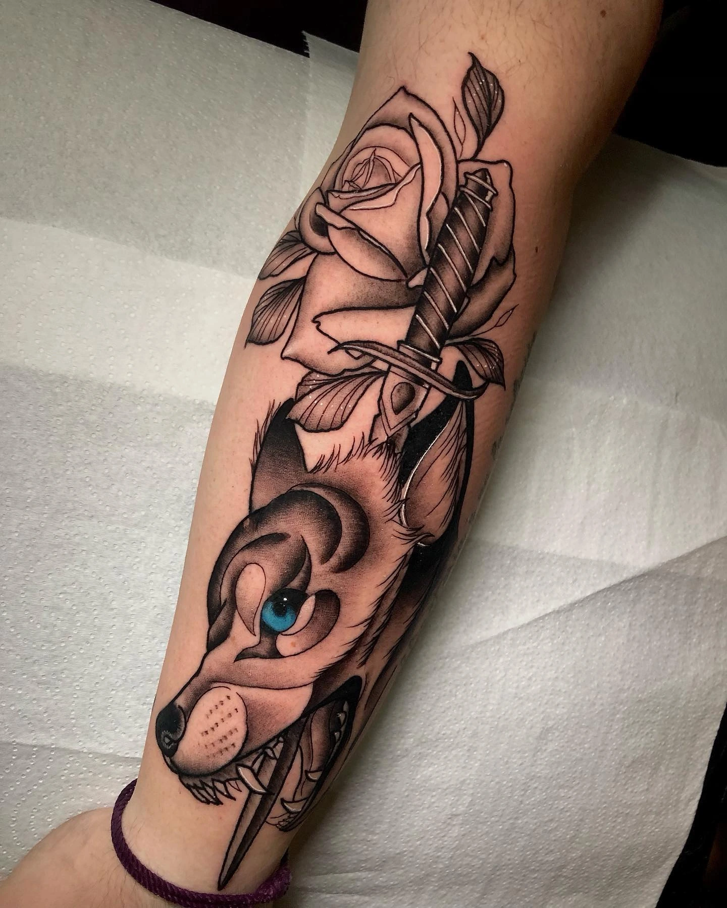 Wolf head with rose and dagger, blue eye accent