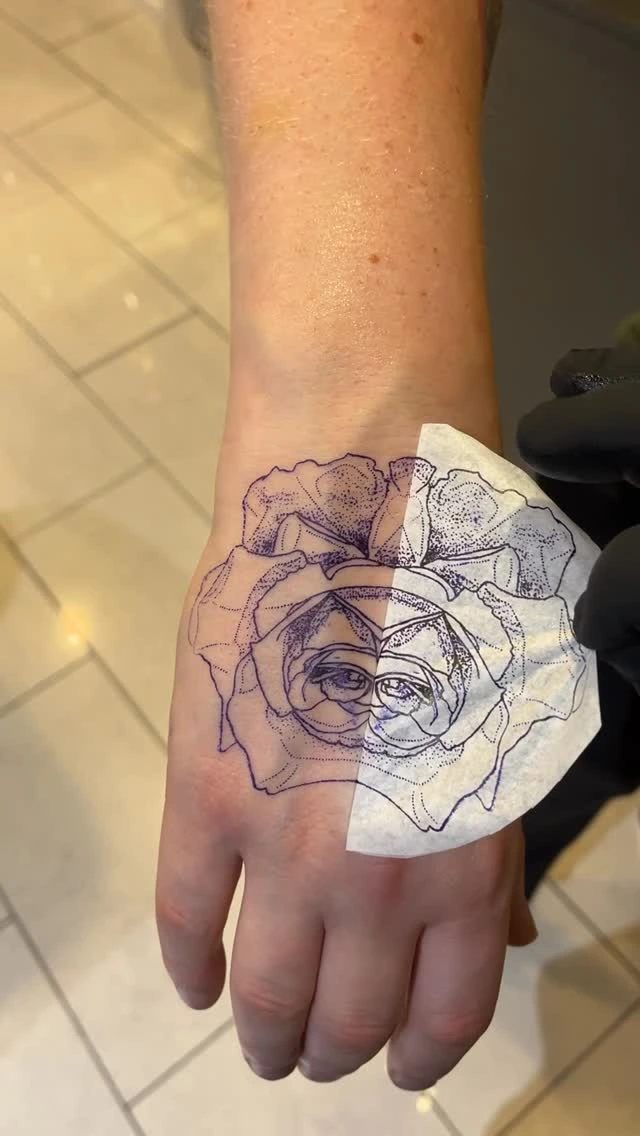 Stencil application of dotwork rose on hand