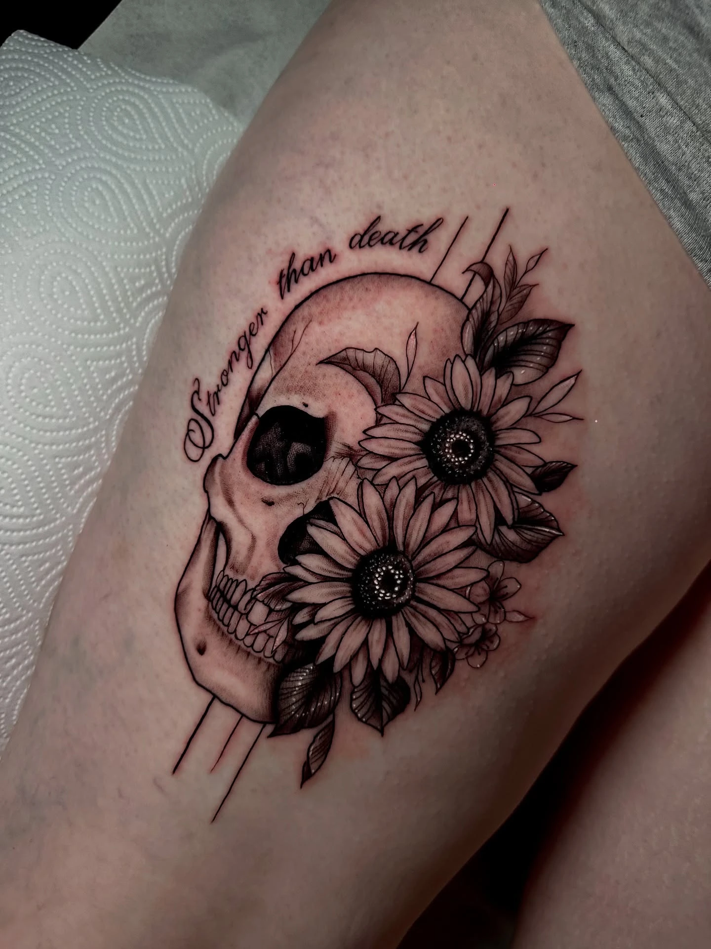 Skull with sunflowers and 'Stronger than death' script — finished view