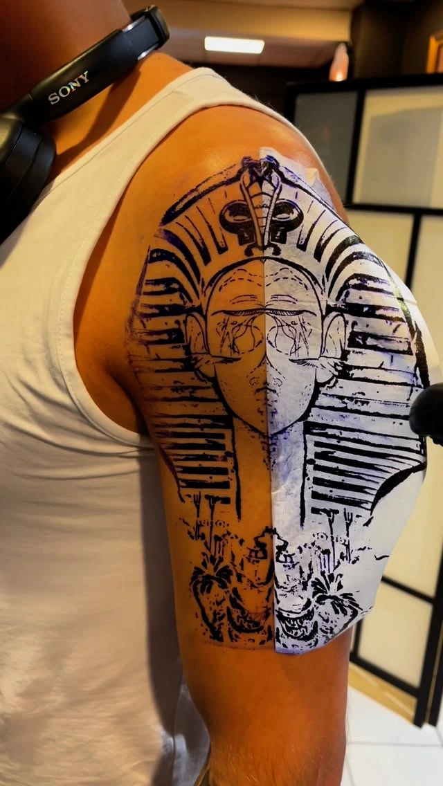 Stencil application of pharaoh piece on the shoulder