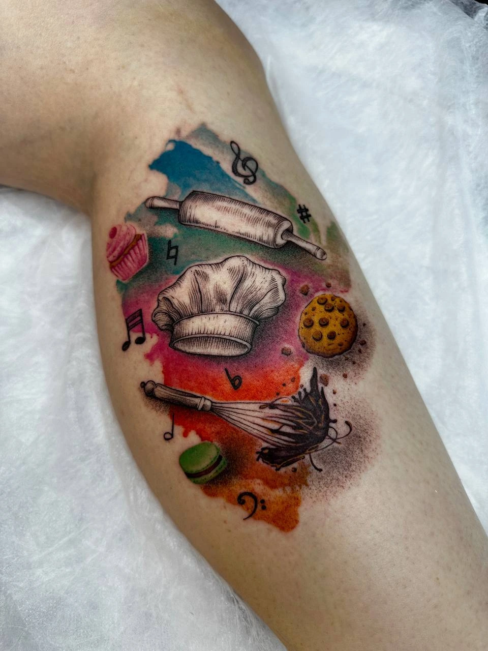 Baker / chef composition, chef hat, rolling pin, whisk, cookie, macaron and music notes on watercolor splatter background