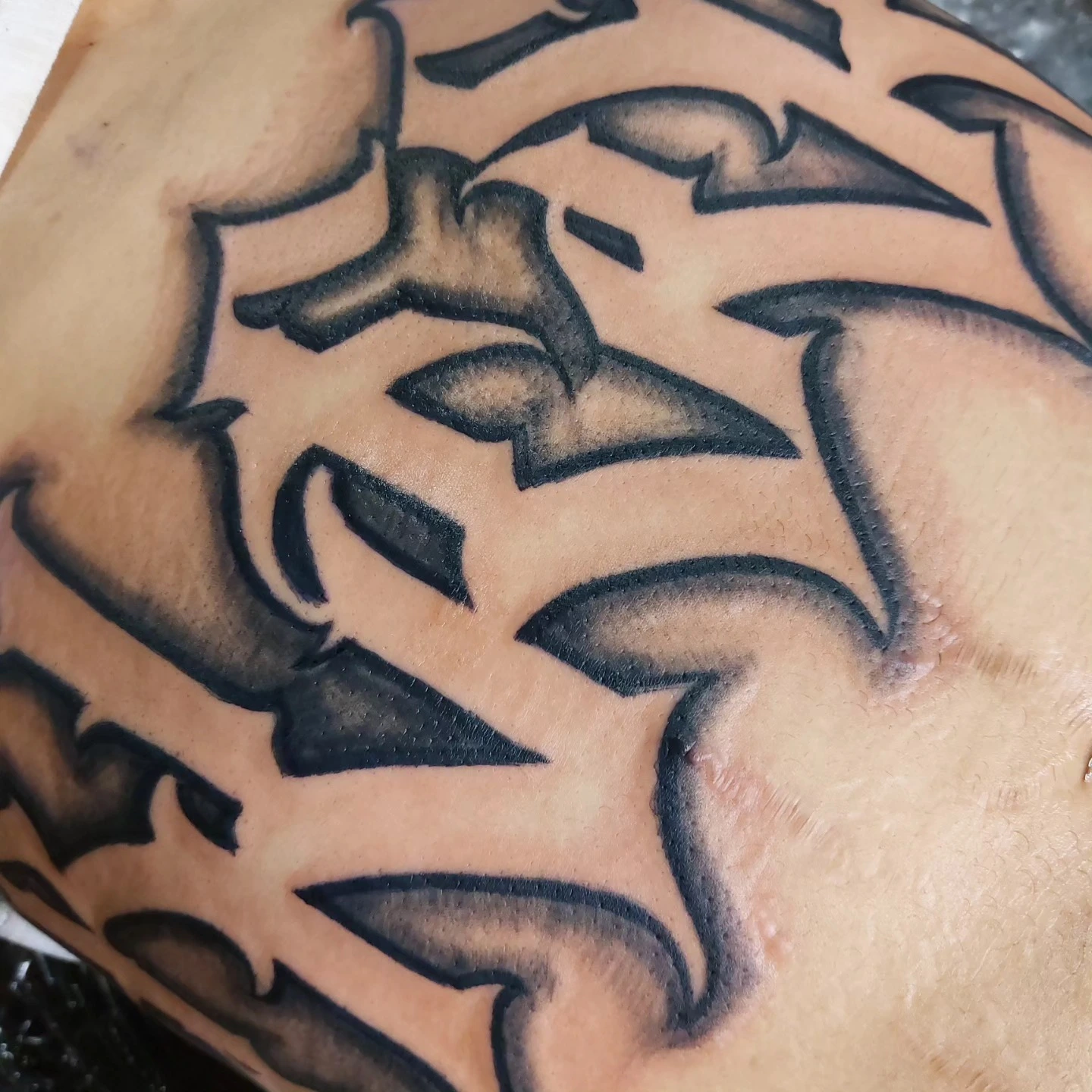 Fine cursive script 'Tiakana Kreia Findley' on forearm
