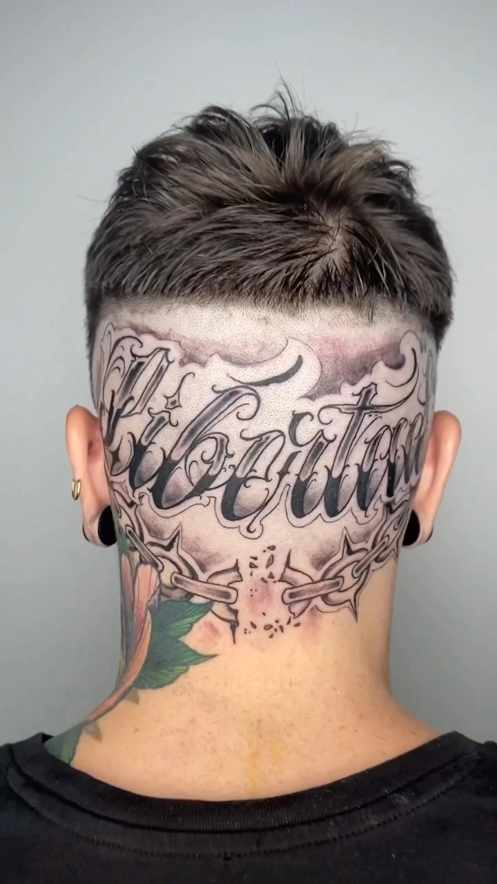 'Libertad' chicano script across scalp/head