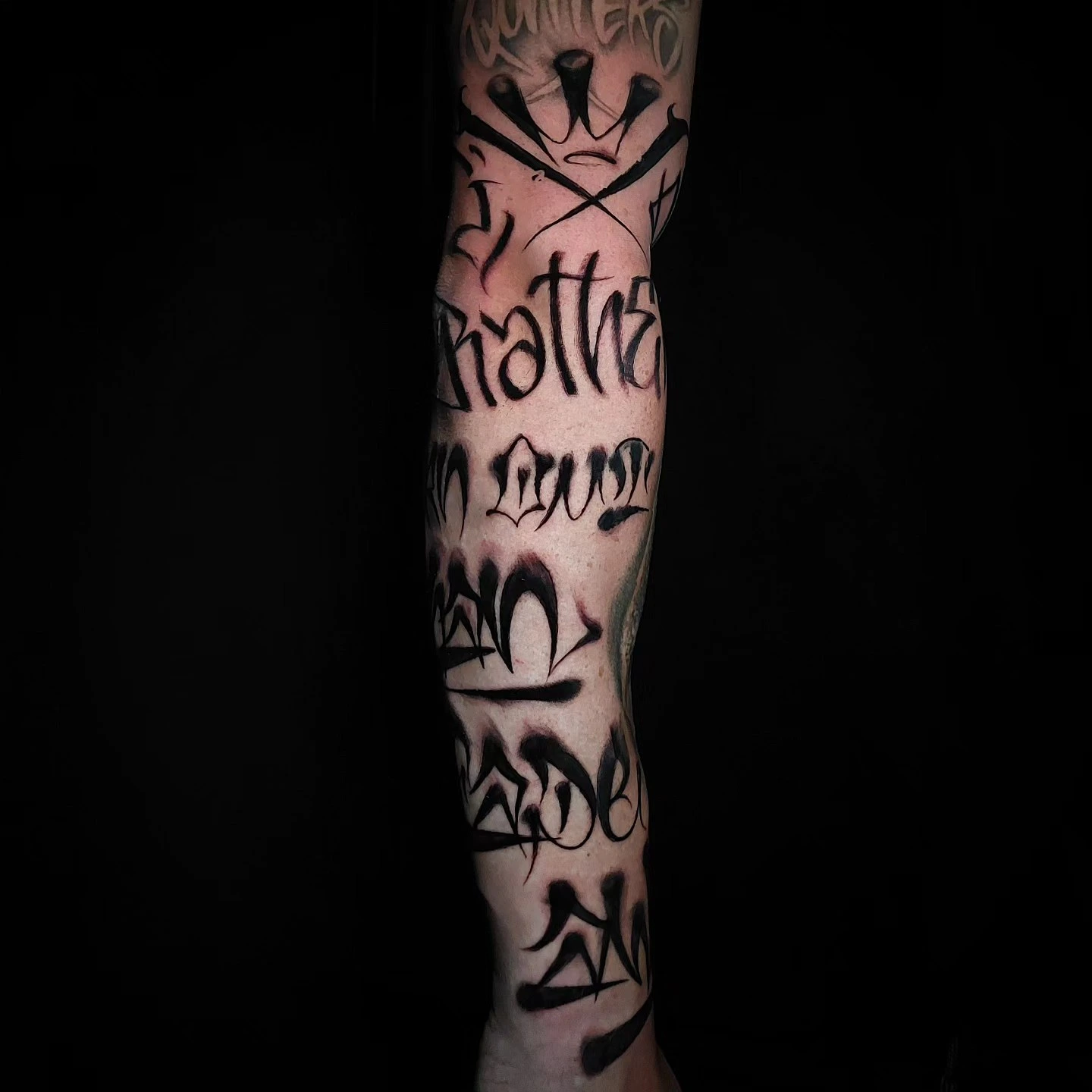 Multi-line freehand graffiti-script forearm sleeve