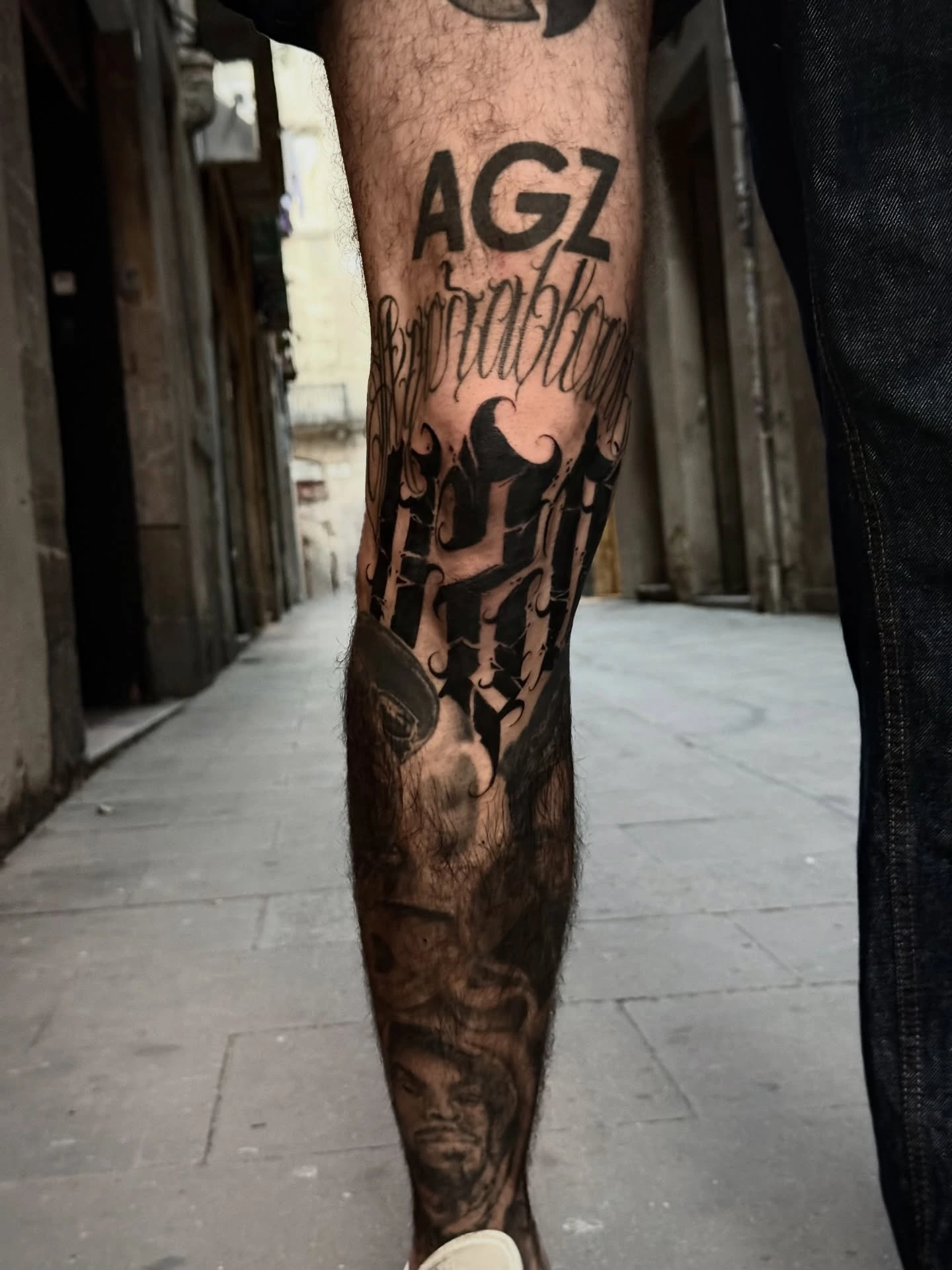 Coiled black snake winding down forearm