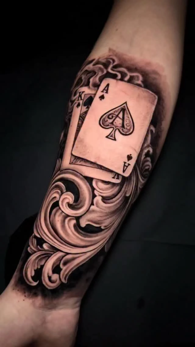 Ace of spades & King playing cards with ornamental scrolls