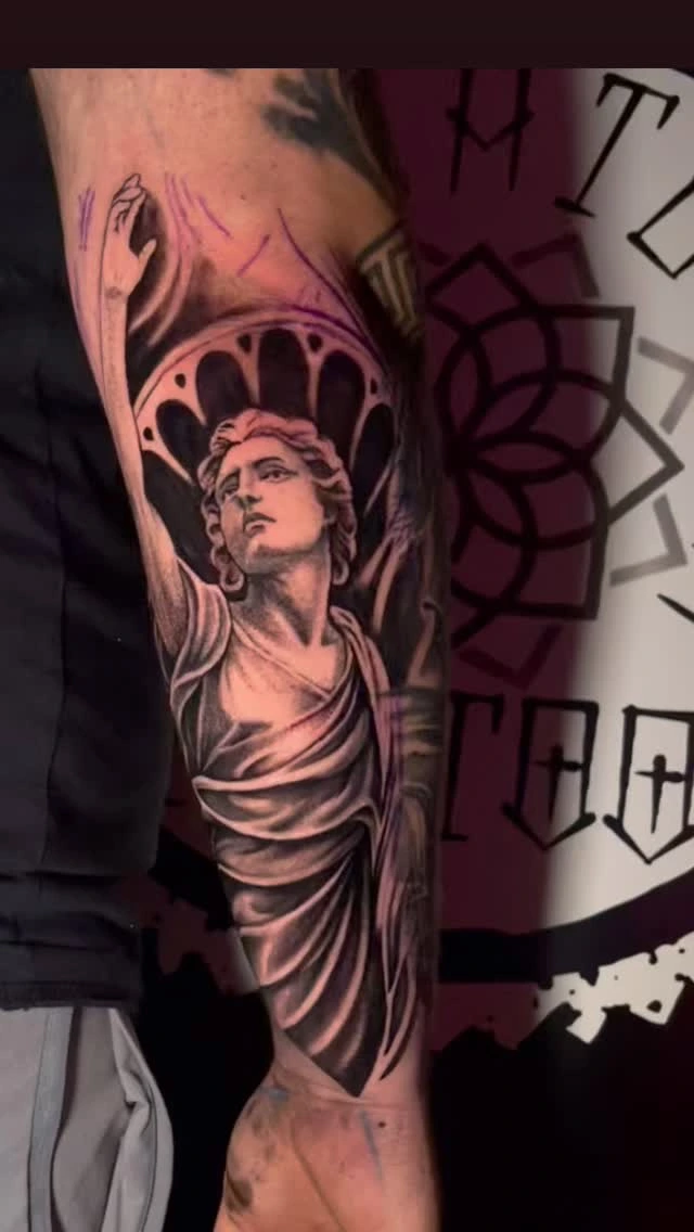 Greek/Roman classical statue (Apollo/Hermes-like) with arm raised, mandala backdrop