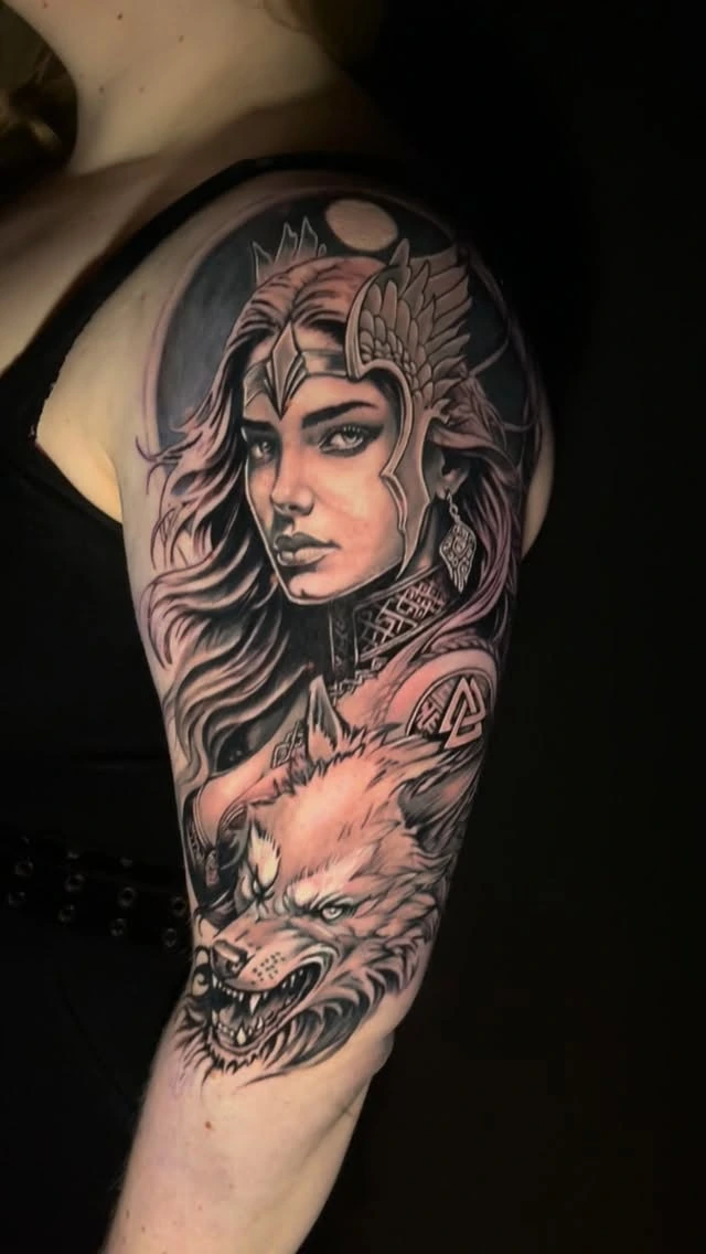 Valkyrie / female Norse warrior with winged helmet and wolf below, valknut symbol