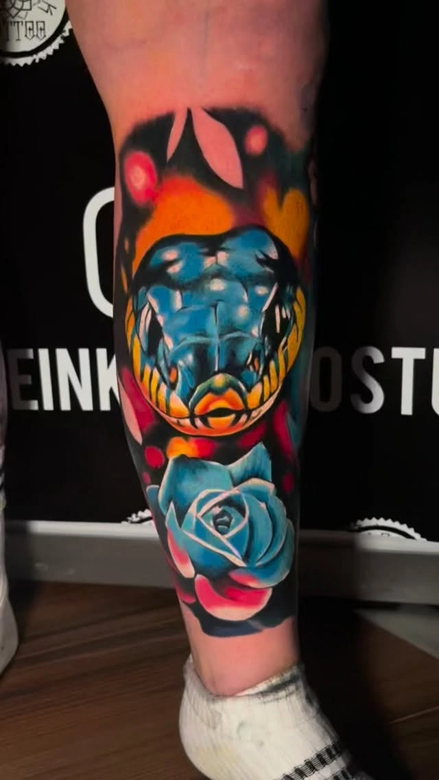 Saturated yellow/blue snake head with blue rose below