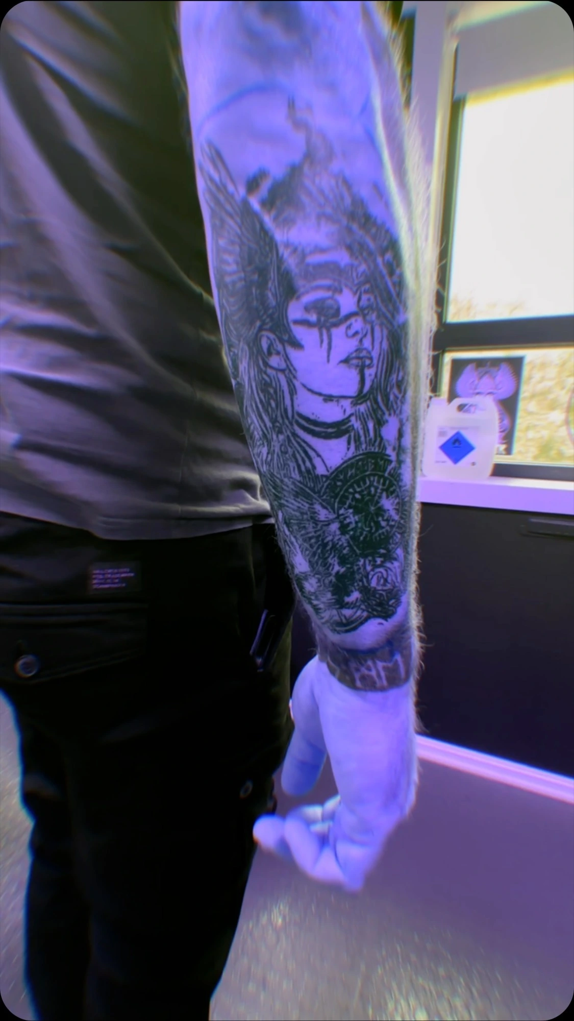 Valkyrie/skull bold blackwork forearm sleeve under purple light