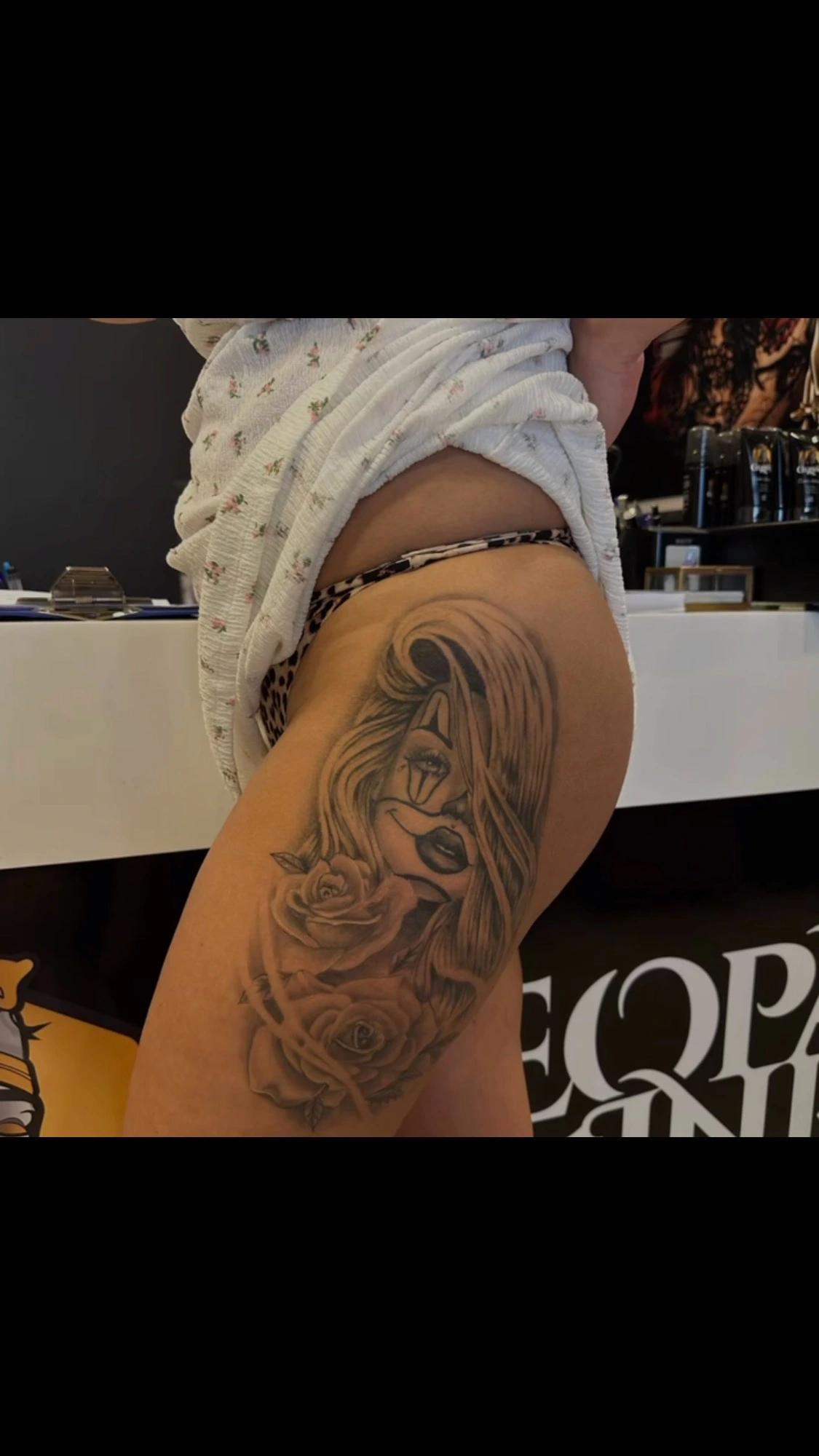 chicano-style 'muerta' painted girl with roses, hip/thigh
