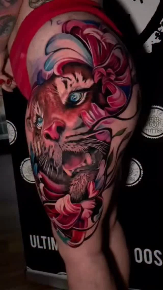 red-and-pink tiger face roaring with floral flourishes, hip/thigh